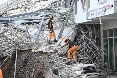 Philippines building collapse leaves 21 missing as rescuers hear voices from rubble