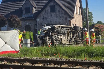 Several hurt in a crash between a train and a minibus, Belgian police say