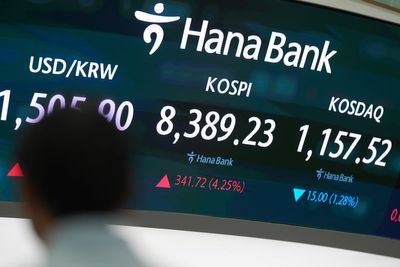 Asian shares are mostly higher, tracking Wall Street's fresh records, and oil prices fall