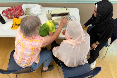 After refugee aid cuts, faith groups help Afghan women connect through sewing