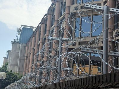 Razor wire put up at new Chinese super embassy site after youths scale gate in security incident