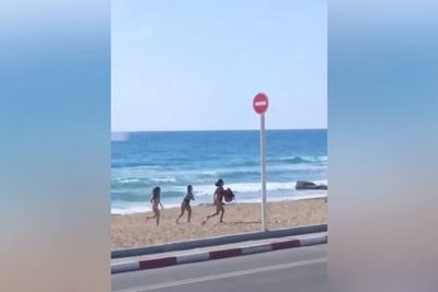 Israel beachgoers flee in panic as projectiles hit sea