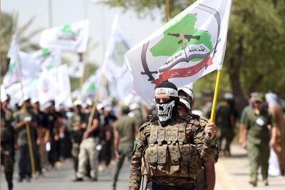 Powerful Iran-backed Iraqi militia says it will start handing its weapons to the state
