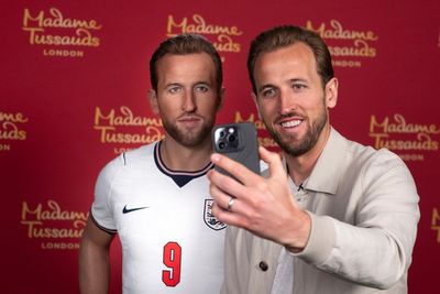 England captain Harry Kane reacts to seeing his own wax figure