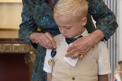 Seriously ill boy gets Queen to present his bravery medal from Scouts