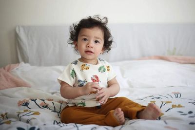 Why do humans take so long to grow up compared to other animals and how brain evolution reshaped human development and survival today?