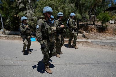 Photos show Lebanese and UN troops take positions in a village vacated by Israeli soldiers