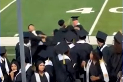 Wild brawl breaks out between cap-and-gown-wearing seniors as names are being called at their graduation