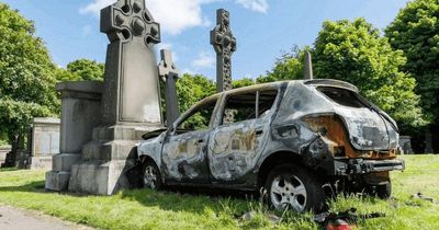 Shock as burnt-out car found sitting on top of grave in Scottish city