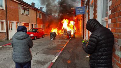 Residents evacuate as Belfast protesters set homes and vehicles on fire as disorder erupts after knife attack