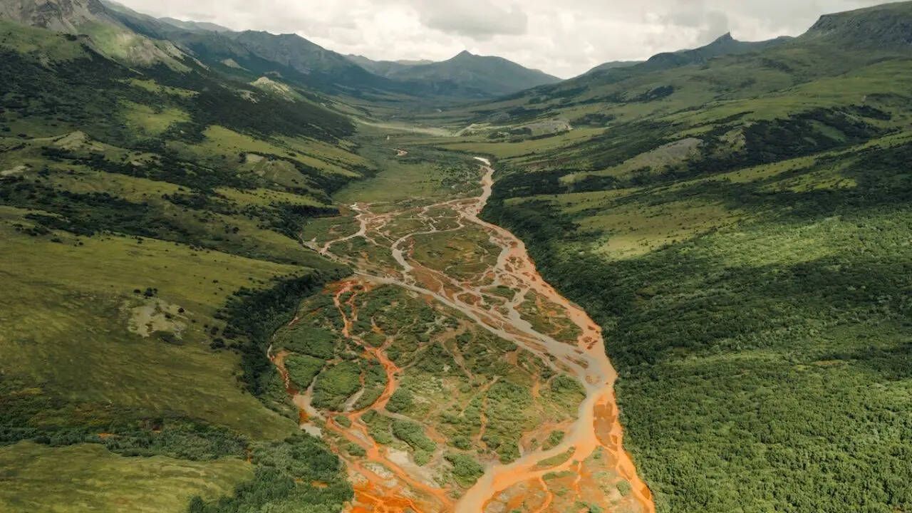 Alaska’s rivers are turning rust-orange and scientists…