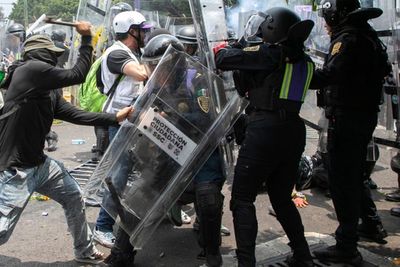 Protesters in Mexico clash with riot police outside stadium during World Cup opener