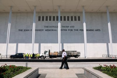 Workers prepare to remove Trump's name from the Kennedy Center, in photos