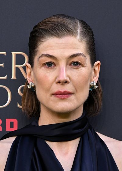 Not again! Rosamund Pike shoots London theatregoer an icy glare after phone alarm left ringing