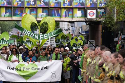 Grenfell demonstrators embrace firefighters during anniversary march