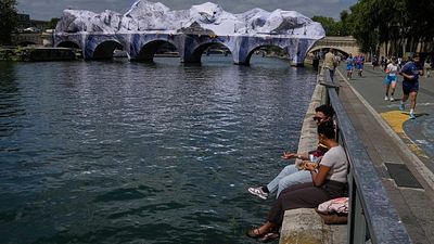 Crowds flock to JR's giant cave installation on Paris' Pont Neuf