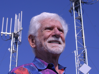 In 1973, Motorola's Martin Cooper called his AT&T rival from a Manhattan sidewalk on a 2.5-pound brick; 50 years later, that phone lives in 7 billion pockets