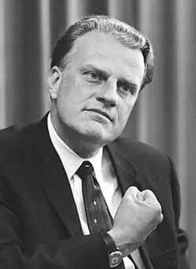 Quote of the Day by Billy Graham: 'A good father is one of the most unsung, unpraised, unnoticed...'-American evangelist's heartfelt quote about the quiet strength of dads
