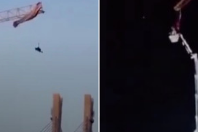 Moment paraglider gets trapped on crane during mishap on jump in China