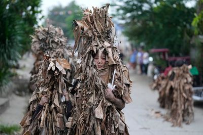 Philippine devotees honor St. John the Baptist with a mud-covered display of faith