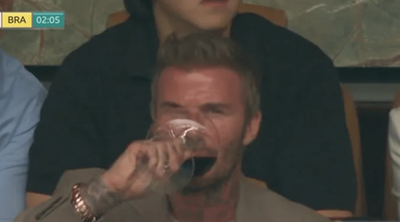 David Beckham glugs red wine with son Cruz at Scotland v Brazil World Cup game