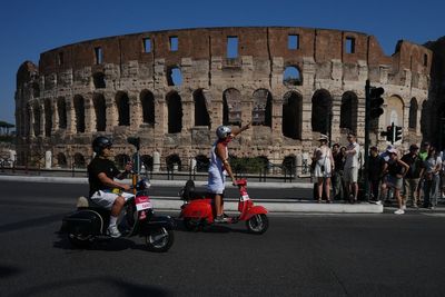 Photos show Vespa enthusiasts buzzing through Rome celebrating the little scooter's 80th anniversary