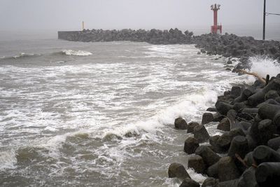 Two tropical storms pound Japan, causing flooding and landslides