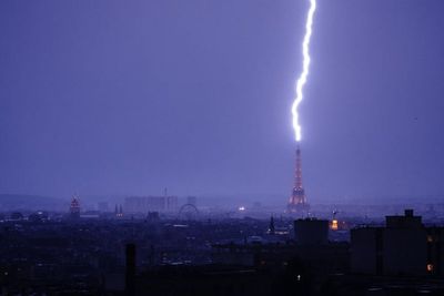 Moment Eiffel Tower is hit by lightning bolt as deadly heatwave grips Paris