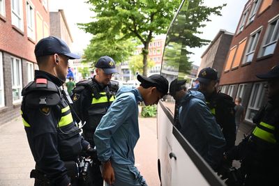 Football fans clash with police in the Hague after Netherlands suffer World Cup heartbreak