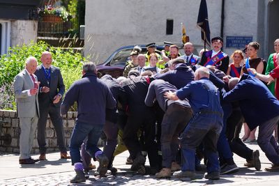 King starts ancient game in Jedburgh and steps back to watch scrum