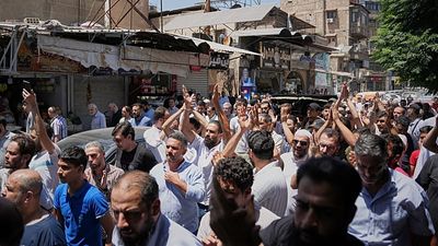 Mourners in Damascus bury cafe bomb blast victims as officials promise justice