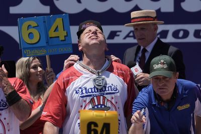 Joey Chestnut easily outpaces Nathan’s hot dog eating contest field but falls short of his own record in 100-degree heat