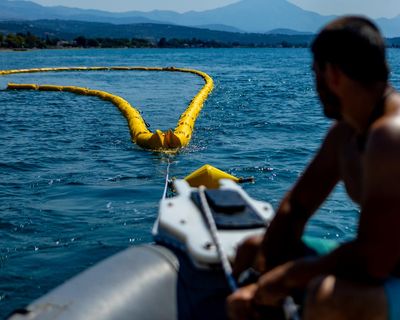 ‘Better safe than sorry’: Greece installs floating barrier to ward off toxic fish
