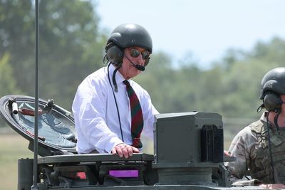 Heavy metal: King rides British Army tank in visit to regiment