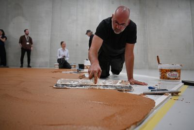Museum floor covered in 800 pounds of peanut butter in sticky tribute to artist