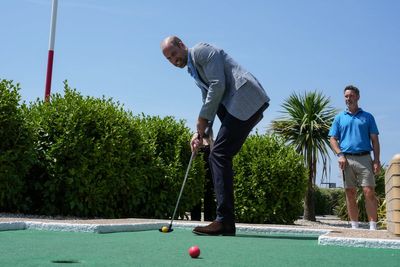 Prince William plays crazy golf and rides funicular during seaside visit