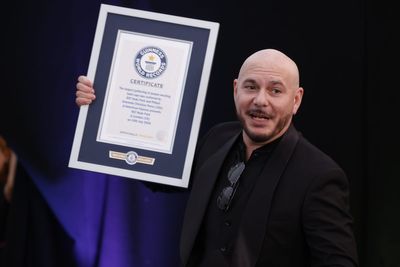 Pitbull sets unique Guinness World Record as thousands wear bald caps in London