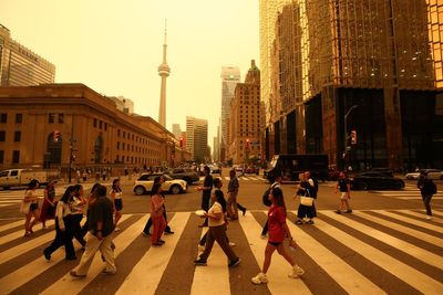 Toronto’s skies turn yellow as dangerous smoke from over 100 wildfires engulfs city