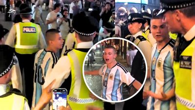 Chaos in London's Piccadilly Circus as police rescue Argentina fan surrounded by crowd of baying England supporters