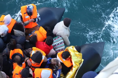Overcrowded migrant dinghy pilot identified by distinctive Christmas jumper