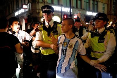 Argentina fan swarmed by England supporters in central London rescued by police