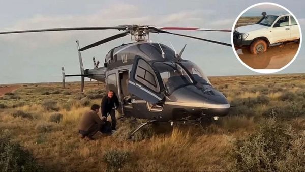 Australian father and son were stranded in the outback for 12 hours after a storm trapped their car; billionaire Tim Roberts, who happened to be flying his helicopter, rescued them