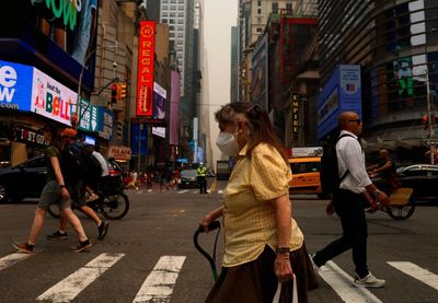 ‘My eyes were stinging’: New Yorkers navigate smoky air and soaring temperatures
