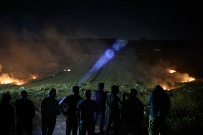 Photos show West Bank Palestinians keeping watch at night as settler violence grows