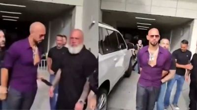 Watch: Andrew Tate appears to pass phone to team member as US Marshals arrest him over UK charges