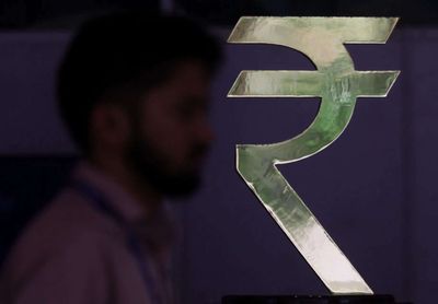 Rupee ends nearly flat as central bank intervention blunts oil strain
