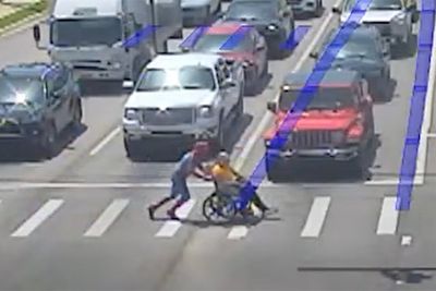 Real-life Spider-Man helps man in wheelchair cross traffic in full superhero costume
