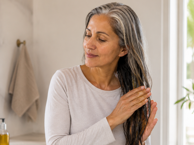 Applying coconut oil before shampooing on gray hair; what it's for and why this care protects the strands