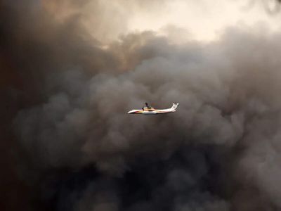 More than 200,000 people flee raging wildfires in France and Spain, some escaping by boat