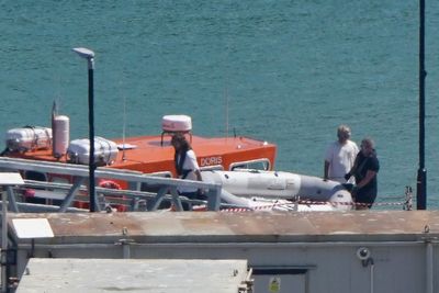 Migrants arrive after rowing tiny dinghy across the Channel